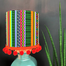 Load image into Gallery viewer, Multi-stripe fabric with mirror copper liner and optional orange pompom lampshade